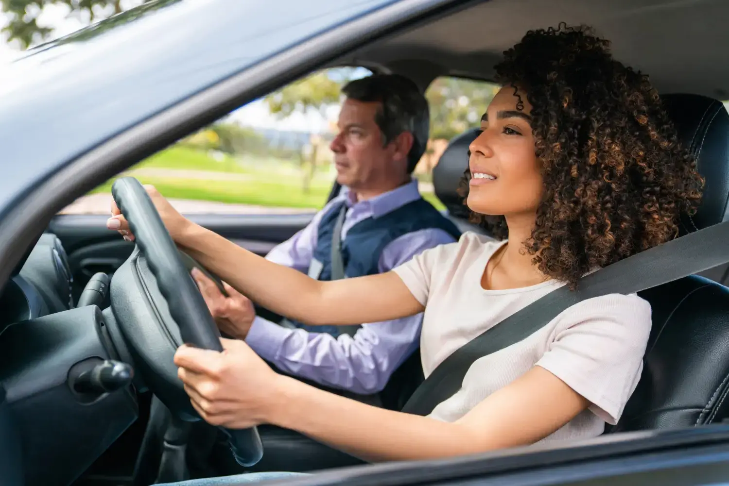Grover Driving Academy instructor with student and Hyundai IONIQ 6